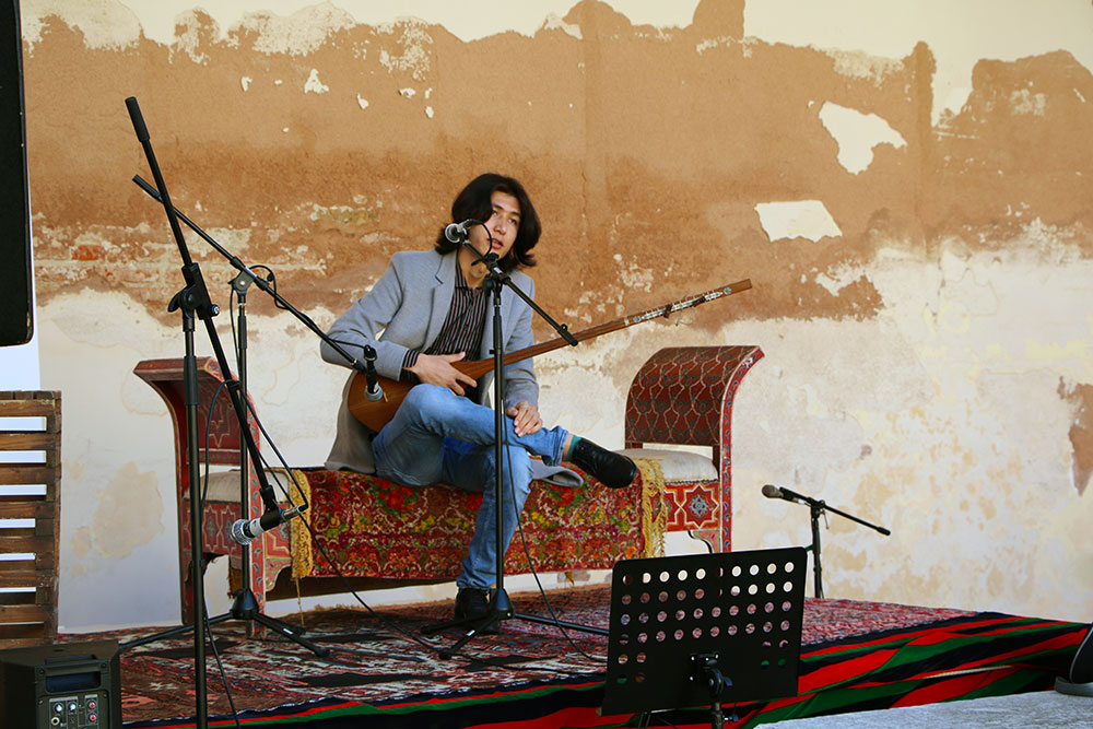 Musician playing the traditional Danbura at Nowruz 2023